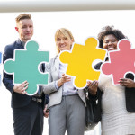 Business people connected by puzzle pieces